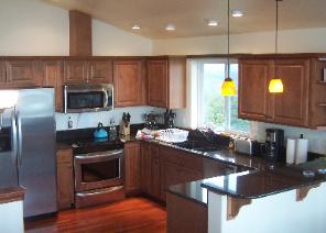 Luxury kitchen with granite countertops, Brazilian hardwood floor, cherrywood cabinets, and stainless steel appliances